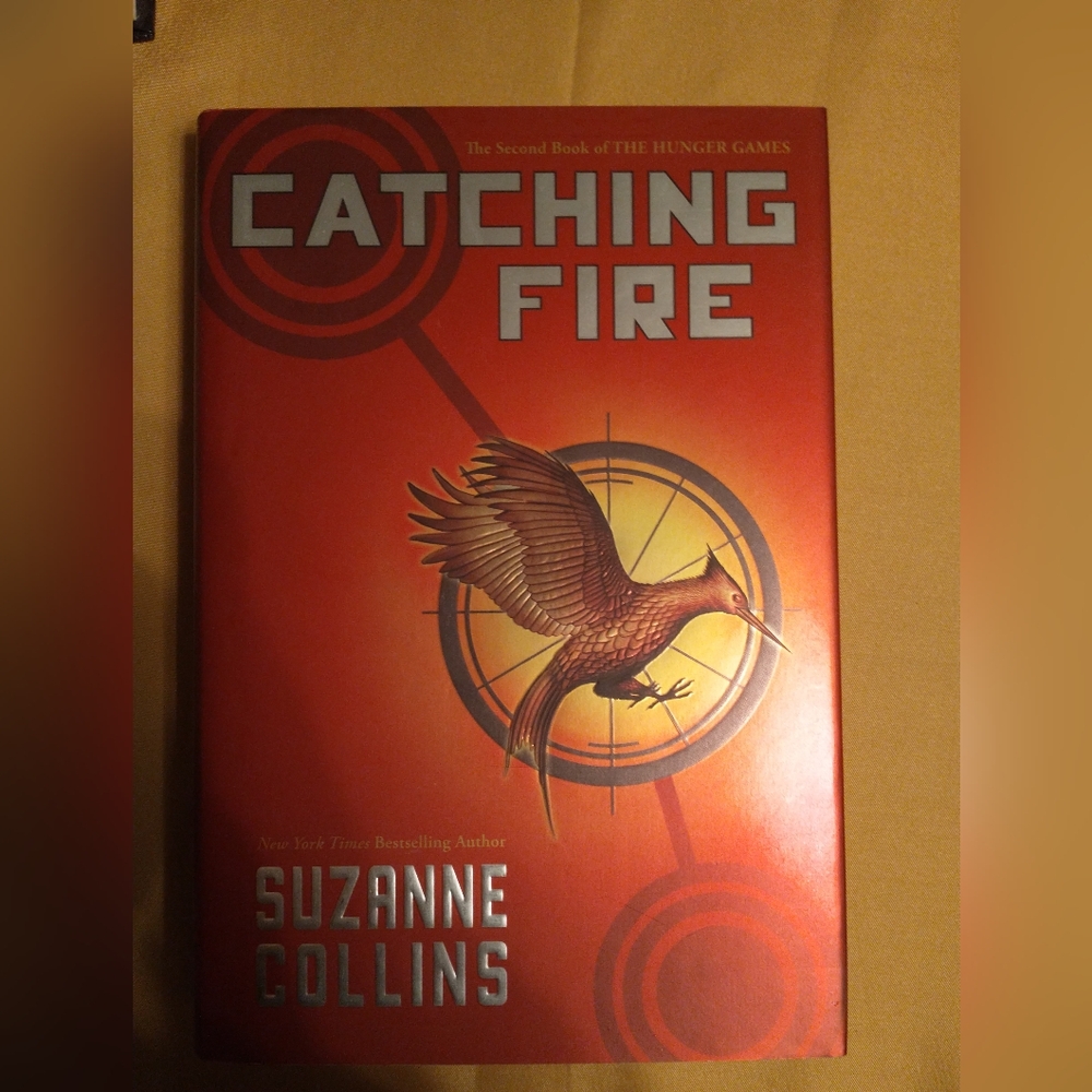 Catching Fire by -Suzanne Collins